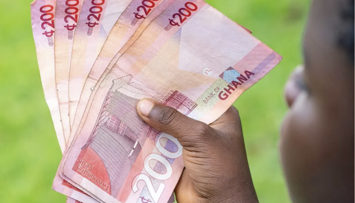 Secured Credit Jumps 73% Despite Fewer Registrations 1 A Ghanaian holding notes