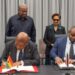 Ghana's Foreign Minister Samuel Okudzeto Ablakwa and Trinidad and Tobago's Foreign and CARICOM Affairs Minister Sean Sobers sign the Air Services Agreement as President John Dramani Mahama and Prime Minister Kamla Persad-Bissessar look on. Photo: The Presidency, Republic of Ghana