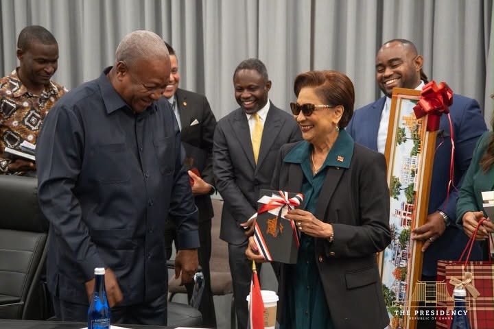 Ghana, Trinidad And Tobago Sign Air Services Agreement At UNGA81 4 Mahama and Persad-Bissessar exchange gifts at the close of the meeting, flanked by members of both delegations. Photo: The Presidency, Republic of Ghana
