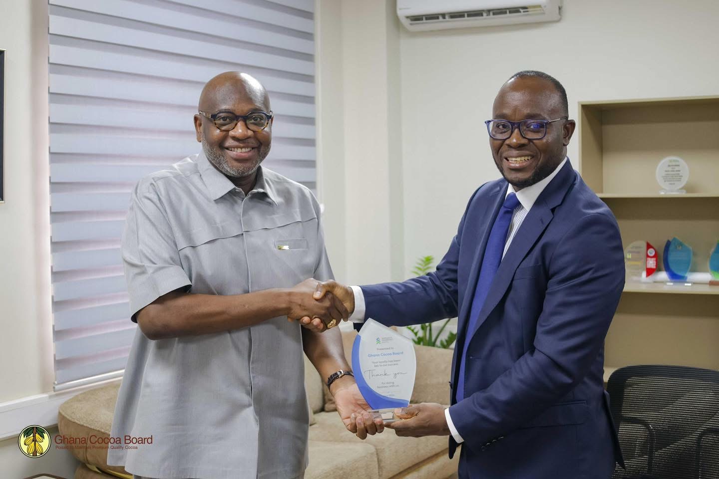 Dr. Ransford Abbey, CEO of COCOBOD, in a Handshake with Mr. Korse Godzi, CEO of Standard Chartered Bank , After a Working Visit to the Cocoa House to Strengthen Partnership on Cocoa Financing