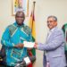 The Minister for Food and Agriculture, Hon. Eric Opoku Receiving the Cash Prize Support from the Head of Olam Agri Ghana, Mr. Baibhav Biswas