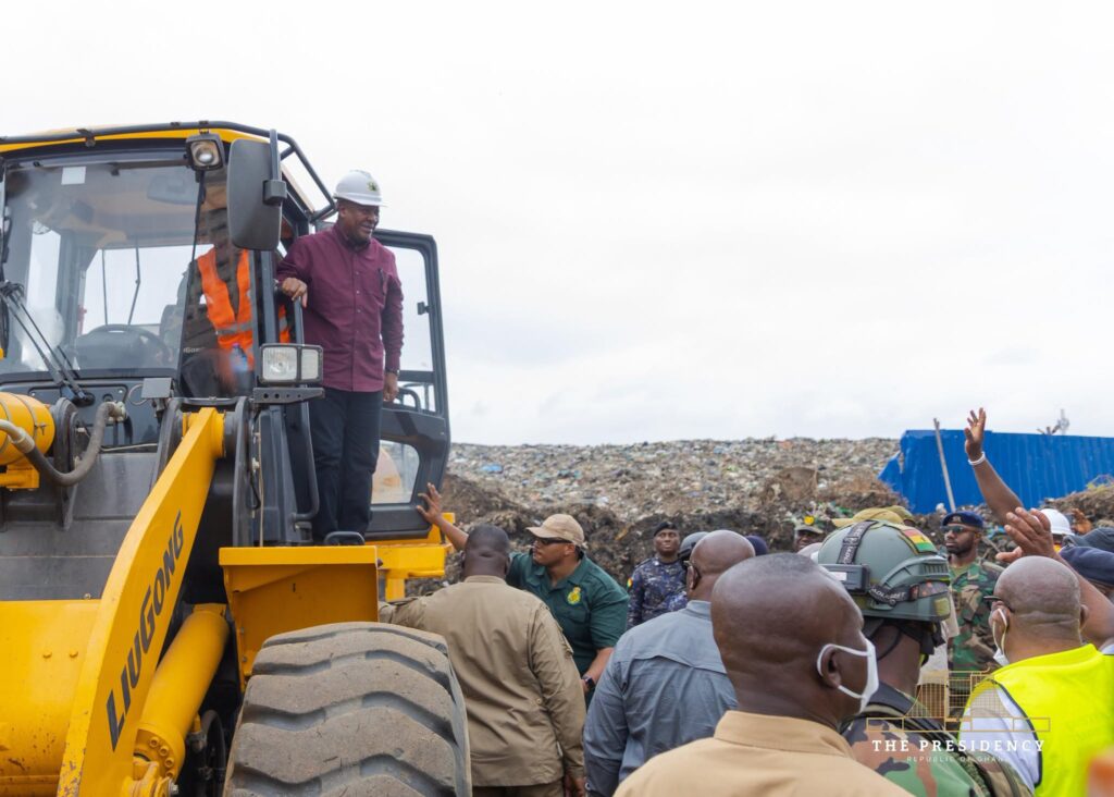 Mahama Unveils Agbogbloshie Urban Renewal Project As Waste Evacuation Begins 4 The President steps onto a wheel loader at the site, with the waste heap behind him. Heavy equipment procured under the District Road Improvement Programme is being deployed on the 90-day operation. Photo: The Presidency, Republic of Ghana