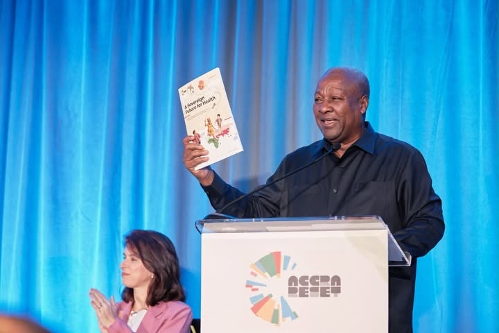 President Mahama holds up "A Sovereign Future for Health," the Accra Reset High-Level Panel report he launched at the event. The report sets out ten recommendations for reforming global health governance and financing.