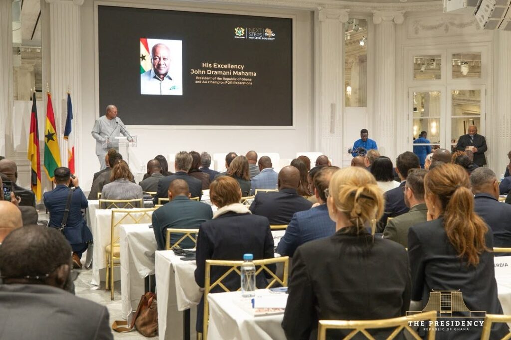 Mahama Rejects Piecemeal Restitution, Wants Permanent Global System For Artefacts 4 President Mahama speaks under a screen introducing him as President of Ghana and African Union Champion for Reparations, before an audience of delegations at the "Next Steps" side event. Photo: The Presidency, Republic of Ghana