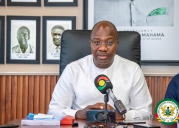 Minister Mahama Ayariga speaks at the Ministry of Local Government, Chieftaincy and Religious Affairs shortly after assuming office, flanked by portraits of his predecessors.