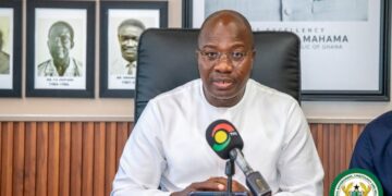 Minister Mahama Ayariga speaks at the Ministry of Local Government, Chieftaincy and Religious Affairs shortly after assuming office, flanked by portraits of his predecessors.