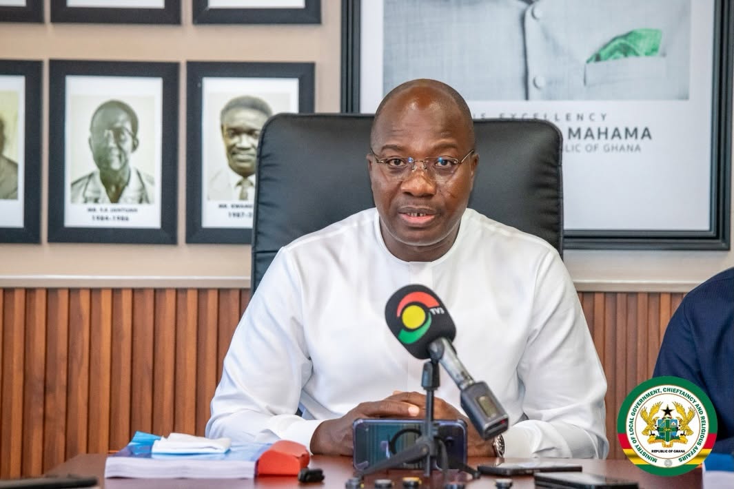 Minister Mahama Ayariga speaks at the Ministry of Local Government, Chieftaincy and Religious Affairs shortly after assuming office, flanked by portraits of his predecessors.