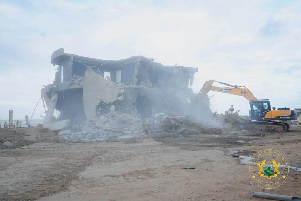 Sunday's Laboma Exercise Was Not a Demolition of the Beach, Stan Dogbe Insists 3 An excavator brings down a beachfront structure at Laboma on Sunday as the Post Flood Mitigation Task Force clears the Kpeshie Lagoon buffer zone.