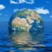 World Leaders Confront Rising Seas Amid Climate Change Threat 17 Earth partially submerged in a vast ocean symbolizing rising sea level