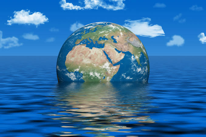 World Leaders Confront Rising Seas Amid Climate Change Threat 1 Earth partially submerged in a vast ocean symbolizing rising sea level