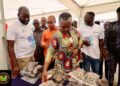 Hon. Emelia Arthur, Minister for Fisheries and Aquaculture Inspecting Fish Products at the Ceremony