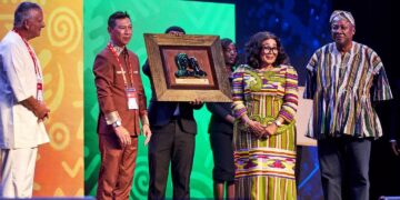 President John Dramani Mahama and First Lady Lordina Mahama stand beside the framed plaque presented to them by the World Assemblies of God Fellowship at the opening of the 10th Triennial Congress in Accra on October 14, 2026.