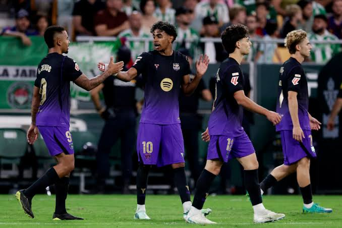 Barcelona players jubilate after scoring against Real Betis