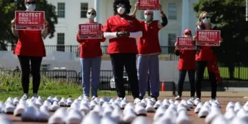 National Nurses United (NNU) display 164 white clogs shoes outside the US Capitol to honor the more than 160 nurses who have lost their lives from COVID-19 in the United States, and to demand the Senate act swiftly to protect nurses on the frontlines in Washington, DC on July 21, 2020. Photo by Olivier DOULIERY / AFP