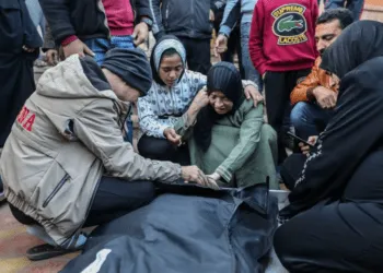 People mourn as they collect the bodies of Palestinians killed in an air strike in Khan Younis, Gaza.