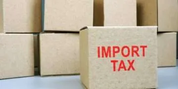 Import tax red stamp on cardboard box.
